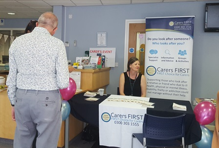 Representatives at the carer's event sat behind the Carers First table